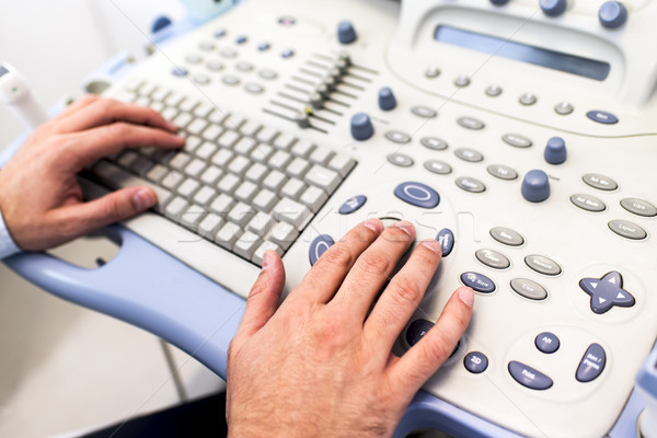 Doctor working on ultrasounds keyboard Stock photo © boggy