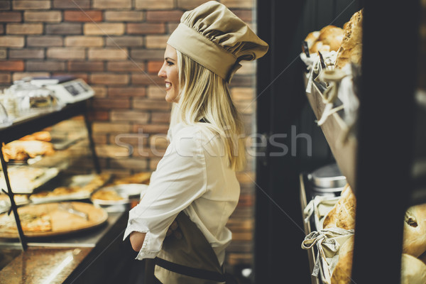 Young woman selling bread in baker shop Stock photo © boggy