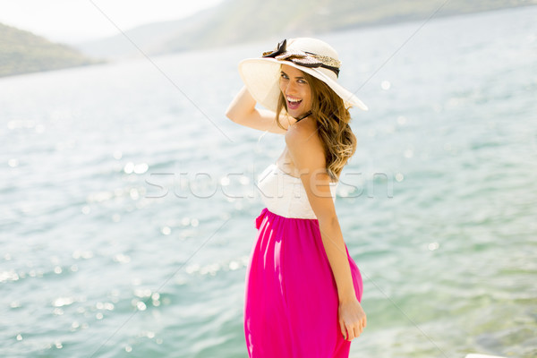 A girl with a colorful shirt, leggings and a cap on the head poses in city  park Stock Photo - Alamy