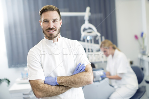 Young woman getting dental treatment while dentist posing Stock photo © boggy