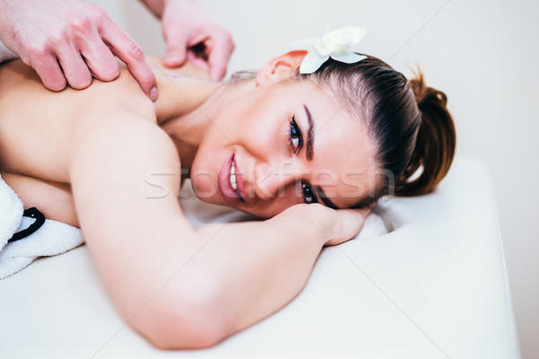Woman relaxing with hand massage at beauty spa Stock photo © boggy