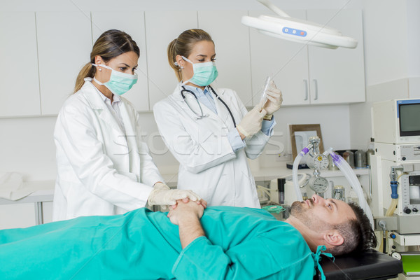 Female doctors preparing patient for intervention Stock photo © boggy