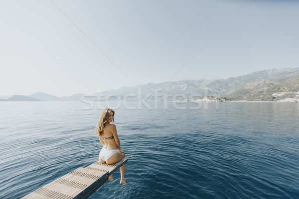 Pretty woman relaxing on the yacht on sea at sunny day Stock photo © boggy
