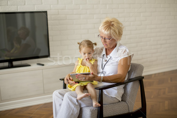 Grandmother reading book to little granddaughter Stock photo © boggy