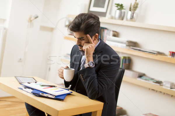 Businessman analyzing investment charts on digital tablet and dr Stock photo © boggy