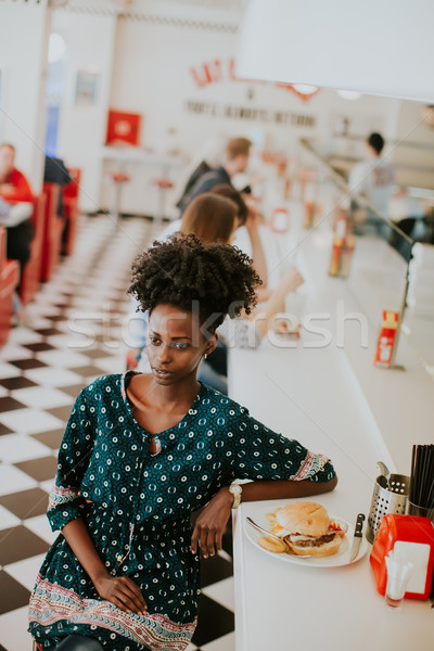 молодые афроамериканец женщину еды Diner портрет Сток-фото © boggy