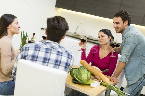 Young people sitting by the table Stock photo © boggy