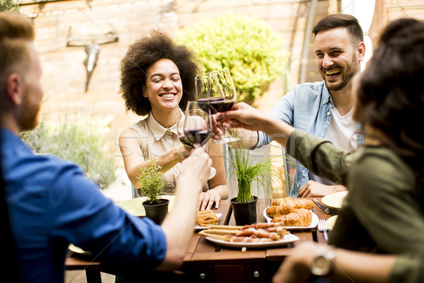 Cheerful young people have lunch in the courtyard and have a fun Stock photo © boggy