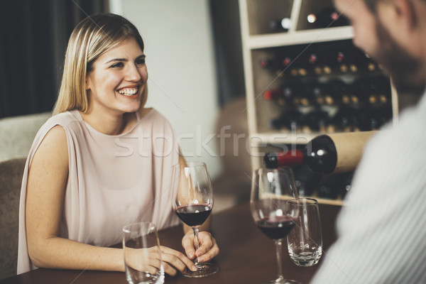 Jóképű fiatal pér randevú ül asztal borozó Stock fotó © boggy