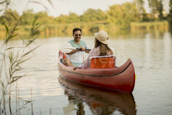 Loving couple rowing on the lake Stock photo © boggy
