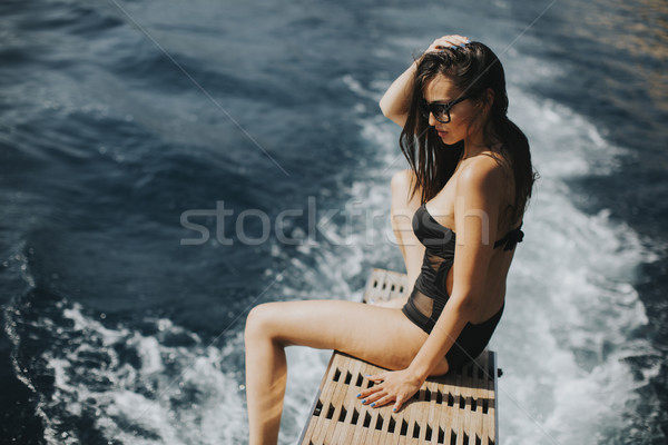 Pretty woman relaxing on the yacht on sea at sunny day Stock photo © boggy