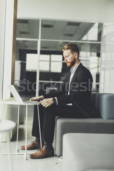 Young redhair man working in the office Stock photo © boggy