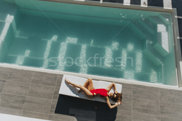 若い女性 プール サンベッド 夏 日 水 ストックフォト © boggy