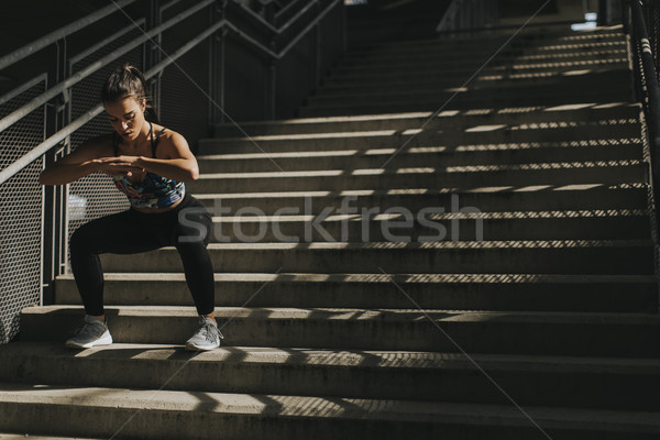 Stock photo: Young woman exercise in urban enviroment by day