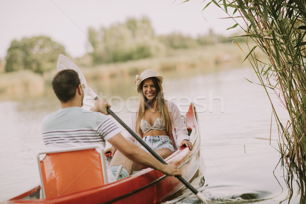 Loving couple rowing on the lake Stock photo © boggy