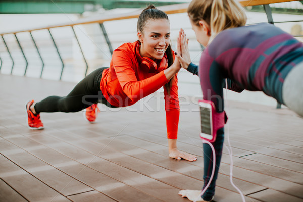 Women doing plank on riverside Stock photo © boggy