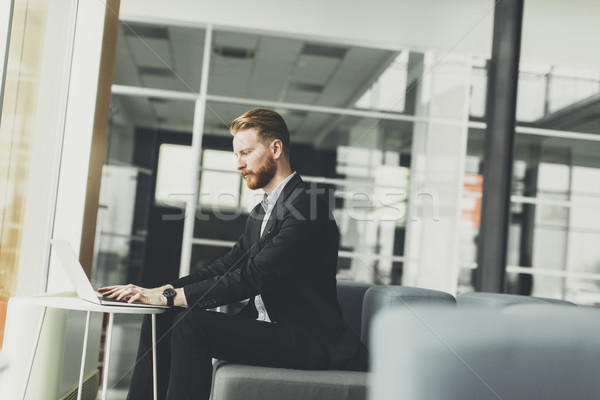 Young redhair man working in the office Stock photo © boggy