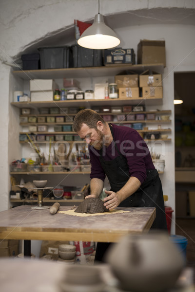 Stock photo: Skilled master preparing clay workpieces for new his creations