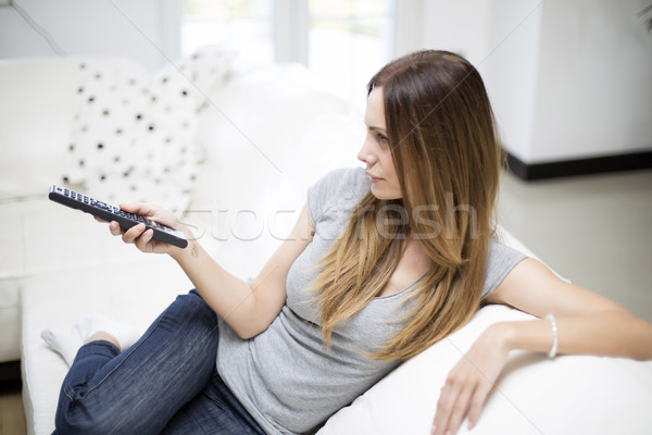 Young woman with remote control Stock photo © boggy