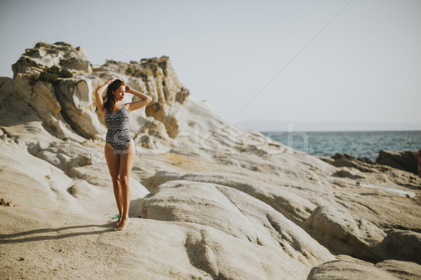 Pretty young woman on the stony beach Stock photo © boggy