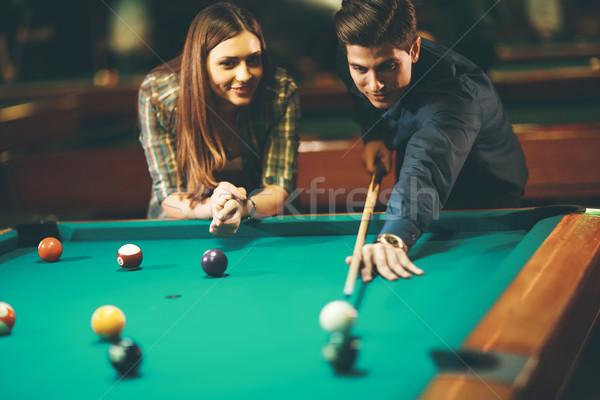 Young couple playing pool Stock photo © boggy