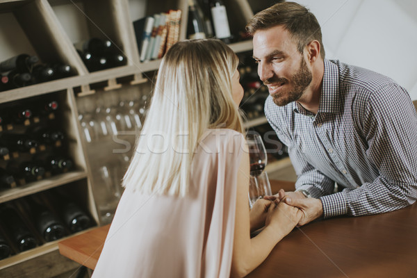 Handsome couple on the date sitting by table in wine bar Stock photo © boggy