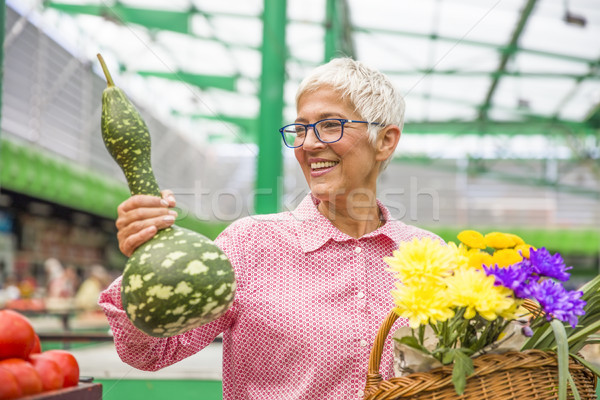 Senior woman buying gourd  on market Stock photo © boggy