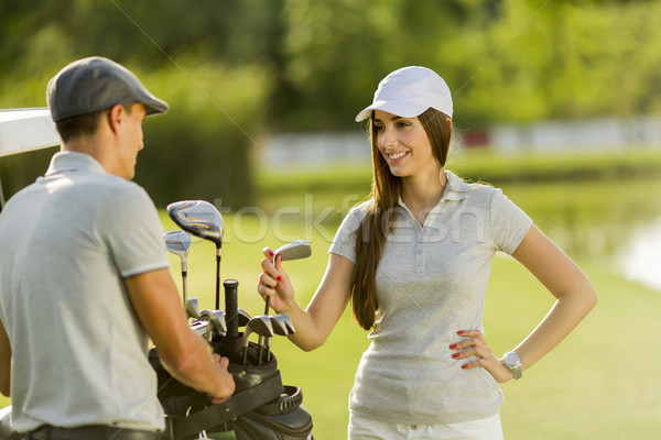 Young couple at golf cart Stock photo © boggy