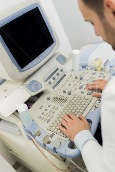 Doctor uses ultrasound to examine patient Stock photo © boggy