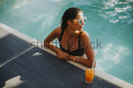Genç ince kadın rahatlatıcı yüzme havuzu sıcak Stok fotoğraf © boggy
