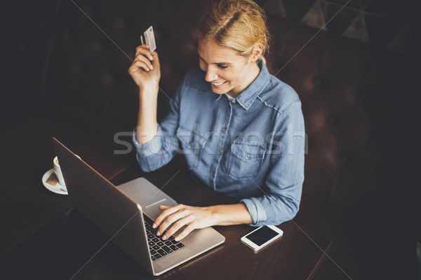 Young woman performs online shopping Stock photo © boggy