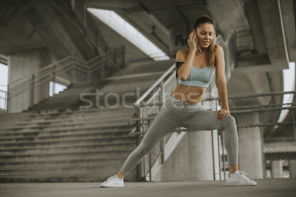 Pretty young woman having exercise in the urban environment Stock photo © boggy