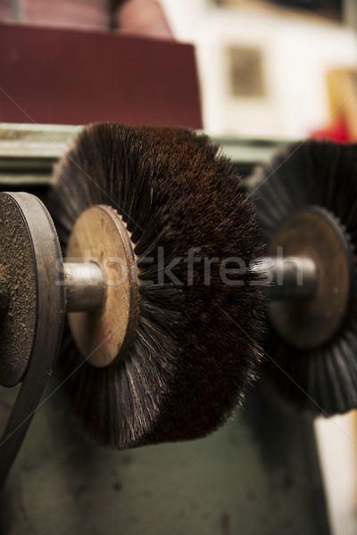 Shoe polisher in the shoemaker workshop Stock photo © boggy
