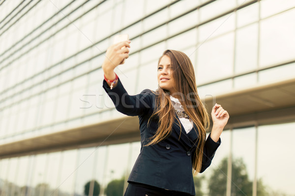 Young woman taking a selfi with mobile phone Stock photo © boggy