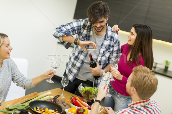 Young people at the table in kitchen Stock photo © boggy