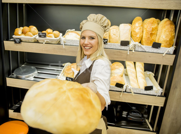 Pretty young woman selling bread in the bakery Stock photo © boggy