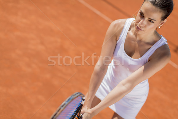 Stock photo: Young woman playing tennis