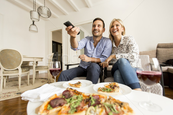 Young couple enjoying eating pizza and watching tv Stock photo © boggy