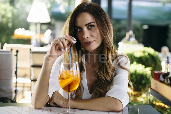 Attractive young woman drinking coctail in cafe outdoor Stock photo © boggy