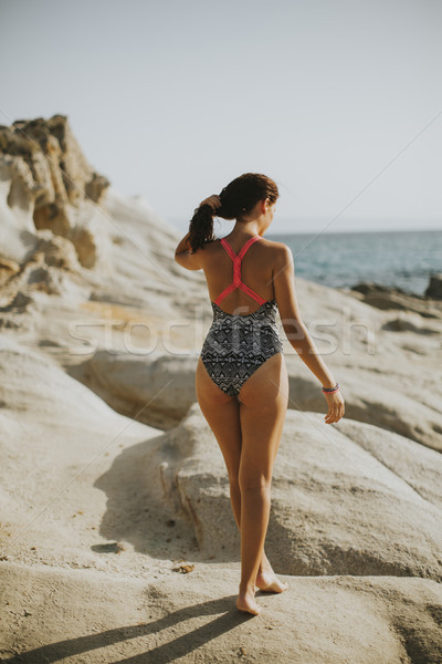 Pretty young woman on the stony beach Stock photo © boggy