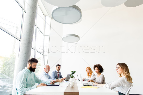 Business people around table during staff meeting Stock photo © boggy