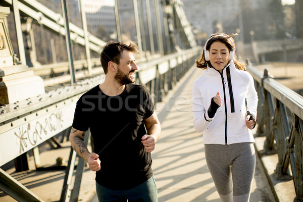 Stock photo: Young couple running in urban enviroment