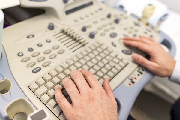 Doctor working on ultrasounds keyboard Stock photo © boggy