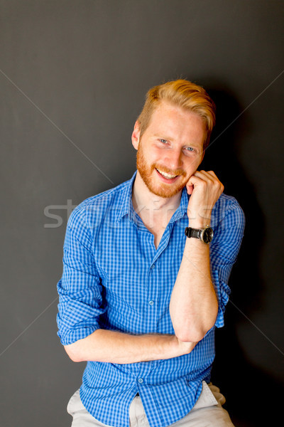 Portrait of ginger young man against wall Stock photo © boggy