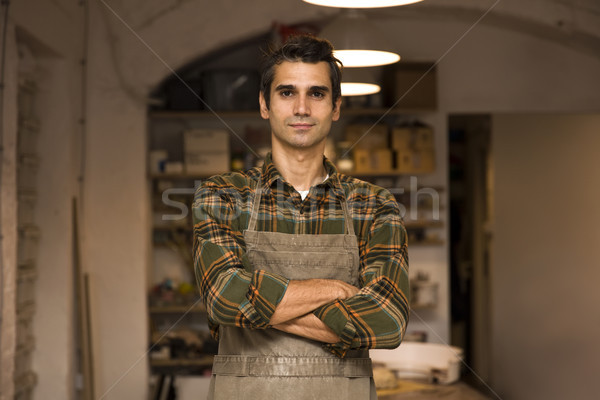 élégant jeune homme posant poterie atelier portrait [[stock_photo]] © boggy