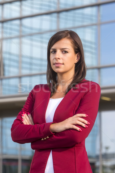 Portrait of young businesswoman in front of office guilding Stock photo © boggy