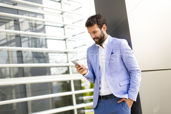 Businessman using mobile phone Stock photo © boggy