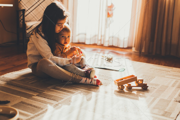 Stock photo: Two little girls playing on the floor in the room