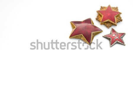 Old red stars from military caps isolated on the white backgroun Stock photo © boggy