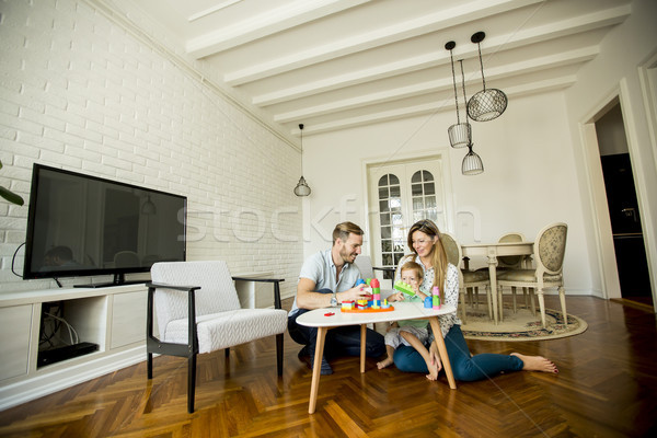 Happy family playing in the living room Stock photo © boggy